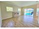 Bright living room with tile floors and an electric fireplace with direct access to the pool at 295 Woodstream Way, Spring Hill, FL 34608