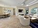 Spacious living area with a large TV and comfortable seating at 295 Woodstream Way, Spring Hill, FL 34608