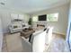 Bright living room with a modern fireplace, comfortable seating, and lots of natural light at 295 Woodstream Way, Spring Hill, FL 34608