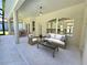 Relaxing patio with seating area overlooking the pool and backyard at 295 Woodstream Way, Spring Hill, FL 34608