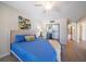 Bedroom with a ceiling fan, queen bed and mirrored closet at 3100 Gulf Blvd # 424, Belleair Beach, FL 33786
