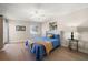 Bright bedroom with a blue comforter and access to a balcony at 3100 Gulf Blvd # 424, Belleair Beach, FL 33786