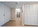 Light-filled hallway with access to bedrooms and kitchen at 3100 Gulf Blvd # 424, Belleair Beach, FL 33786