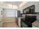 Sleek kitchen with black appliances and granite countertops at 3100 Gulf Blvd # 424, Belleair Beach, FL 33786