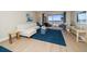 Living room with sectional sofa and sliding doors to balcony at 3100 Gulf Blvd # 424, Belleair Beach, FL 33786