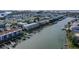 Aerial view of waterfront community with colorful buildings, private docks, and boat access to bay at 322 Windrush Blvd # 2, Indian Rocks Beach, FL 33785