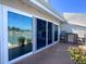 Lovely balcony features a waterfront view, chairs, and sliding doors for indoor/outdoor living at 322 Windrush Blvd # 2, Indian Rocks Beach, FL 33785
