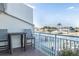 Balcony view with seating area overlooking a canal with boats and waterfront homes at 322 Windrush Blvd # 2, Indian Rocks Beach, FL 33785