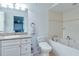 Bathroom with a white vanity, jacuzzi tub, and stylish fixtures at 322 Windrush Blvd # 2, Indian Rocks Beach, FL 33785