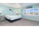 Bedroom featuring bright natural light with turtle wall art at 322 Windrush Blvd # 2, Indian Rocks Beach, FL 33785
