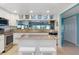 Kitchen with granite countertops, stainless steel appliances and glass front cabinets at 322 Windrush Blvd # 2, Indian Rocks Beach, FL 33785