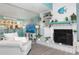 Inviting living room featuring a fireplace, open shelving, and views into the adjacent kitchen area at 322 Windrush Blvd # 2, Indian Rocks Beach, FL 33785