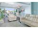 Spacious living room featuring a waterfront view, comfortable seating, and bright, airy atmosphere at 322 Windrush Blvd # 2, Indian Rocks Beach, FL 33785