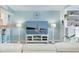 Comfortable living room with a large TV, fireplace, and stylish decor for relaxation and entertainment at 322 Windrush Blvd # 2, Indian Rocks Beach, FL 33785