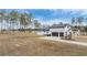 Home's side view, showcasing a modern farmhouse design and solar panels at 35545 Pony Pond Rd, Dade City, FL 33523