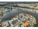 Waterfront home with a mature landscaped lawn and an attached two-car garage on a quiet cul-de-sac at 407 Blackhawk Cir, Sun City Center, FL 33573