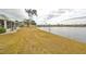 Expansive backyard with manicured landscaping sloping down to a tranquil lake view, perfect for outdoor enjoyment at 407 Blackhawk Cir, Sun City Center, FL 33573