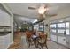 Dining room with a large dining table, wood floors, and an open view to the kitchen and lanai at 407 Blackhawk Cir, Sun City Center, FL 33573