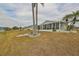 Charming home exterior with a lovely sunroom addition and well-maintained landscaping at 407 Blackhawk Cir, Sun City Center, FL 33573