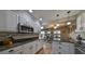 Bright kitchen featuring white cabinets, granite countertops, a mosaic backsplash, and stainless steel appliances at 407 Blackhawk Cir, Sun City Center, FL 33573