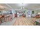 Spacious open floorplan with wood floors connecting the kitchen, dining room, and living area at 407 Blackhawk Cir, Sun City Center, FL 33573