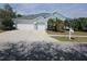 Two-story house with light blue exterior, two-car garage, and palm trees at 5125 Silver Charm Ter, Wesley Chapel, FL 33544