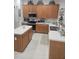 Spacious kitchen with oak cabinets, an island, and stainless steel appliances at 5125 Silver Charm Ter, Wesley Chapel, FL 33544