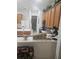 Kitchen with oak cabinets, an island, and a breakfast bar at 5125 Silver Charm Ter, Wesley Chapel, FL 33544