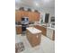Spacious kitchen with oak cabinets, island, and stainless steel appliances at 5125 Silver Charm Ter, Wesley Chapel, FL 33544