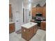 Kitchen with oak cabinets, island, and stainless steel appliances at 5125 Silver Charm Ter, Wesley Chapel, FL 33544
