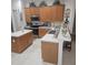 Kitchen boasts oak cabinets, an island, and stainless steel appliances at 5125 Silver Charm Ter, Wesley Chapel, FL 33544