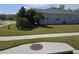 Side yard of the house showing a grassy area and sidewalk at 5125 Silver Charm Ter, Wesley Chapel, FL 33544