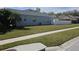 House's side yard with a well-maintained lawn and sidewalk at 5125 Silver Charm Ter, Wesley Chapel, FL 33544