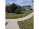 Landscaped side yard with a grassy area and sidewalk at 5125 Silver Charm Ter, Wesley Chapel, FL 33544