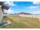 Fenced backyard with fire pit and plenty of grass space at 5493 Blue Azure Dr, Wimauma, FL 33598