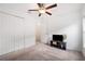 Cozy bedroom with ceiling fan and media console at 5493 Blue Azure Dr, Wimauma, FL 33598