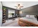 Bedroom with a home office setup and backyard view at 5493 Blue Azure Dr, Wimauma, FL 33598