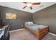 Simple bedroom with ceiling fan and workspace at 5493 Blue Azure Dr, Wimauma, FL 33598
