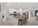 Open kitchen with island, granite counters, and stainless steel appliances at 5493 Blue Azure Dr, Wimauma, FL 33598