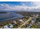 An aerial view of a house by the water, with boats and other houses nearby at 5946 Bayou Grande Ne Blvd, St Petersburg, FL 33703
