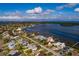 Aerial view of a house near the waterfront with boats in the distance at 5946 Bayou Grande Ne Blvd, St Petersburg, FL 33703