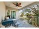 Relaxing balcony with fan, seating, and views of the street at 5946 Bayou Grande Ne Blvd, St Petersburg, FL 33703