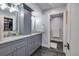 Modern bathroom with dual sinks, updated fixtures, vanity storage, and sleek black tile flooring at 5946 Bayou Grande Ne Blvd, St Petersburg, FL 33703