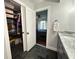 Bathroom featuring sleek black flooring, walk-in closet, and convenient access to main bedroom at 5946 Bayou Grande Ne Blvd, St Petersburg, FL 33703