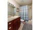 Bathroom with a granite vanity, framed mirror, and a shower/tub combo at 5946 Bayou Grande Ne Blvd, St Petersburg, FL 33703