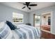 Bedroom featuring hardwood floors, a ceiling fan, and access to a private balcony at 5946 Bayou Grande Ne Blvd, St Petersburg, FL 33703