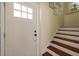 Bright entryway featuring a white door, staircase, and neutral decor, offering a welcoming transition into the home at 5946 Bayou Grande Ne Blvd, St Petersburg, FL 33703
