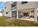 Exterior view featuring covered outdoor lounge area and sprawling yard at 5946 Bayou Grande Ne Blvd, St Petersburg, FL 33703