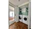 Convenient laundry room with washer, dryer, storage cabinets, and access to the patio at 5946 Bayou Grande Ne Blvd, St Petersburg, FL 33703