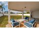 Outdoor living space featuring covered patio with comfortable lounge seating and backyard view at 5946 Bayou Grande Ne Blvd, St Petersburg, FL 33703